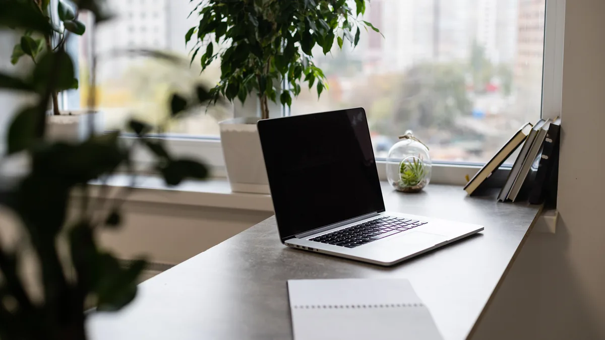 A simple home desk setup by a window, where a grounding mat usually lives