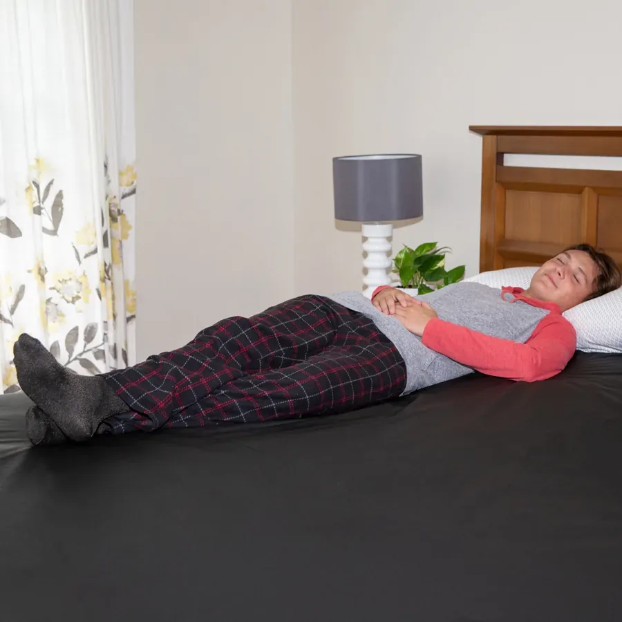 The Earthing Elite Mattress Cover on a bed, a fully conductive black surface covering the whole mattress