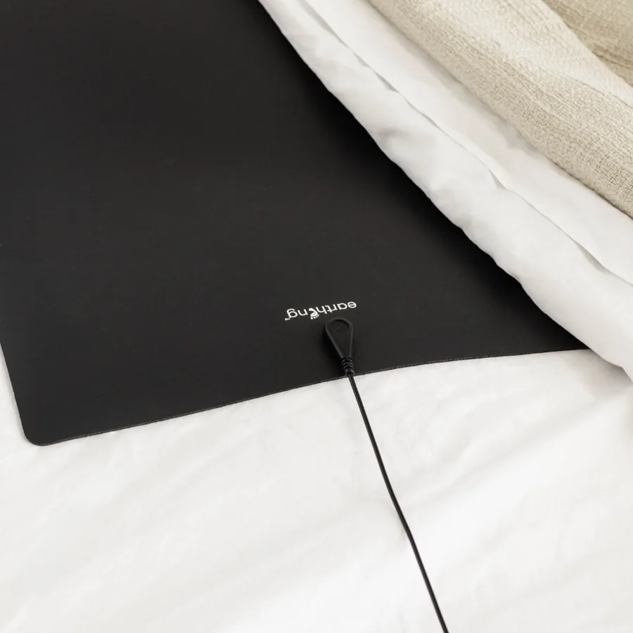 The Earthing Universal Mat Kit, a black conductive mat with its grounding cord