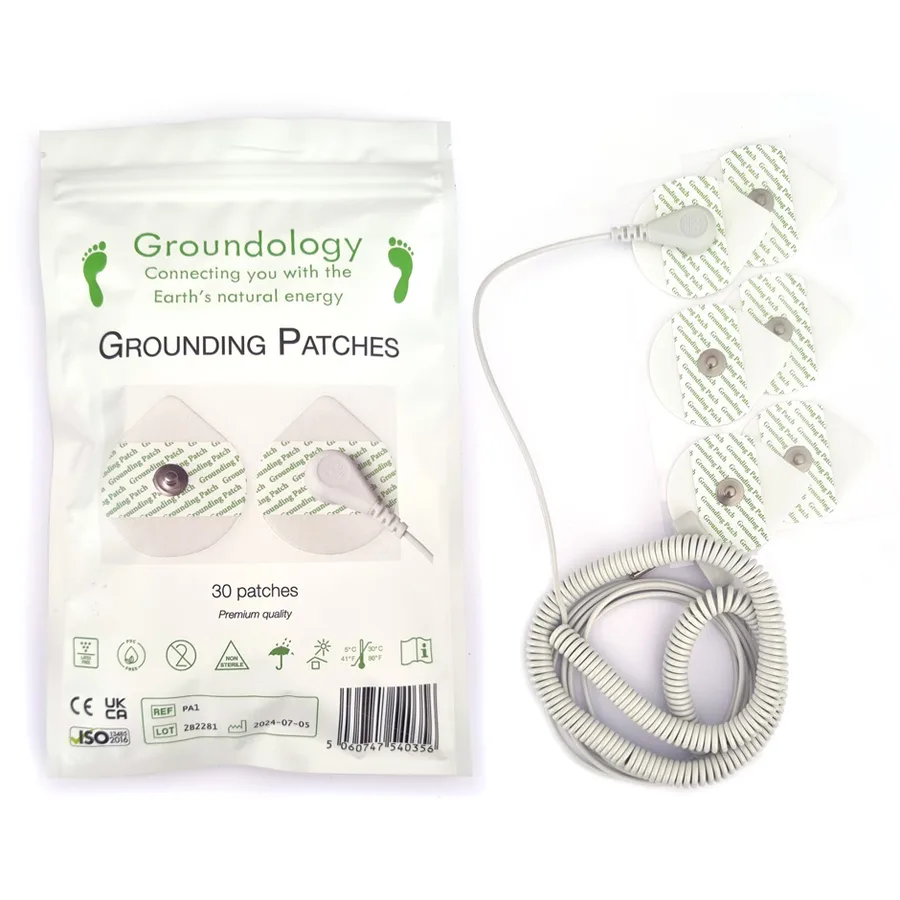A Groundology Grounding Patches pouch of 30 patches beside loose round gel patches and the coiled connection cord