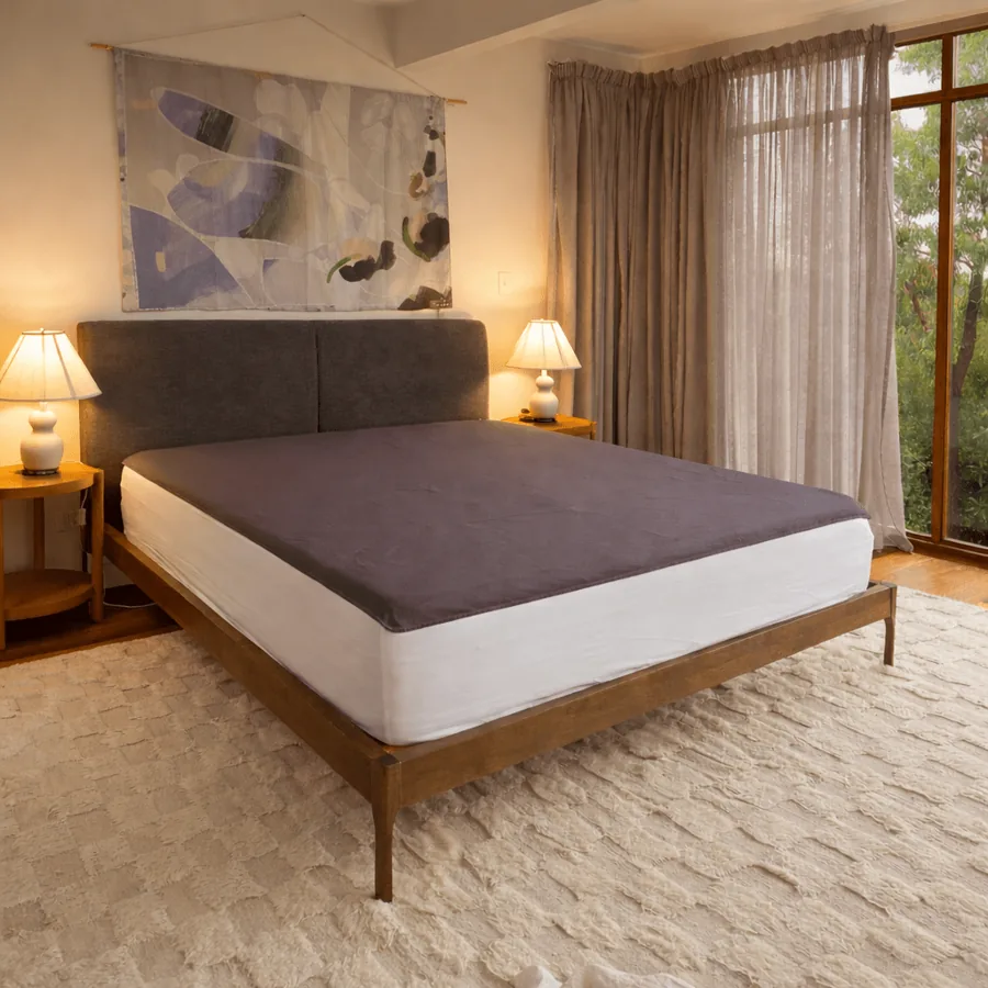 The Premium Grounding stainless steel grounding sheet fitted on a bed